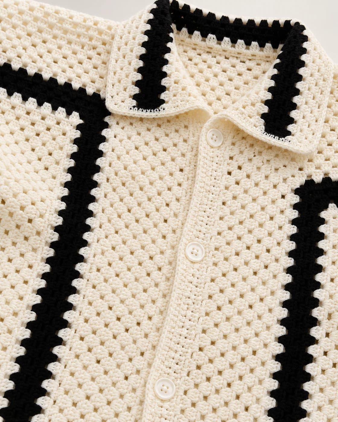 Close-up of the crochet stitches, collar and buttons