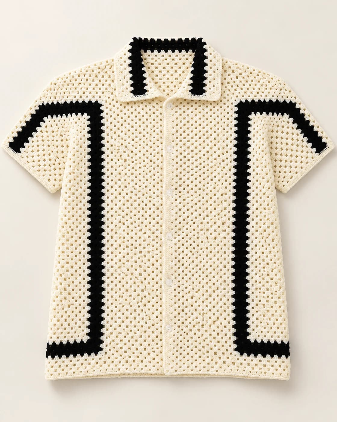 Cream and black crochet shirt on a warm studio background